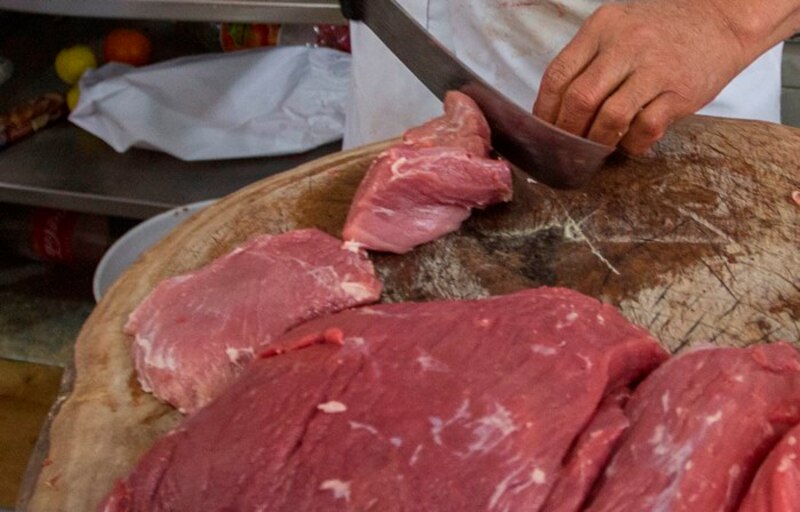 Carnicero cortando carne