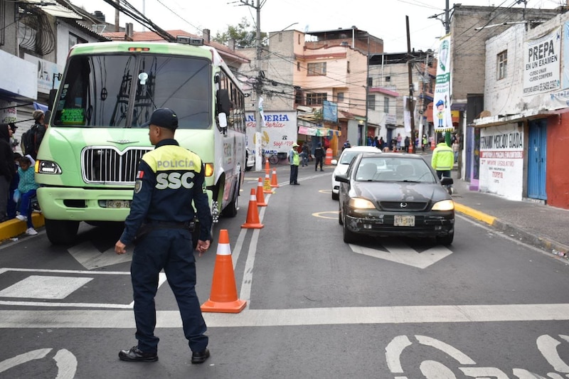 Un policía de la Ciudad de México detiene el tráfico en una calle concurrida.