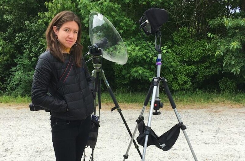 Mujer con equipo de grabación de audio en un bosque