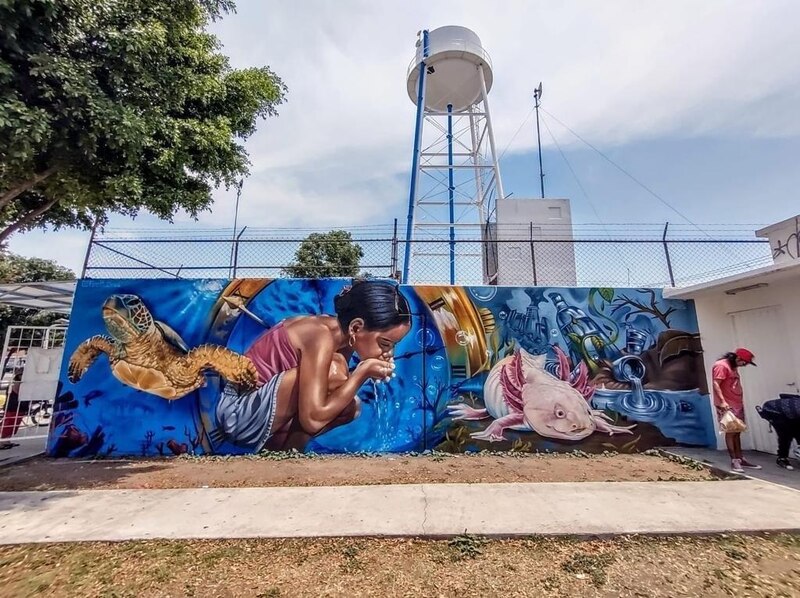 Mural de niña bebiendo agua de un reloj