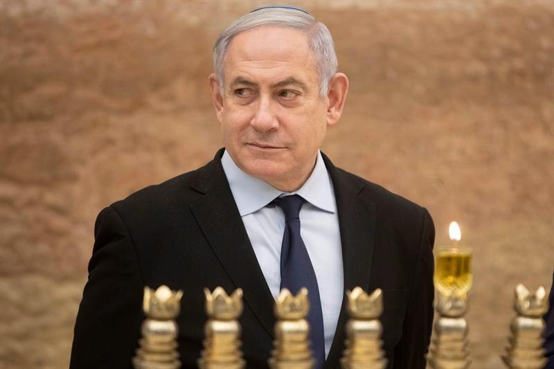 El primer ministro israelí, Benjamin Netanyahu, enciende una vela durante la ceremonia de Janucá en el Muro de las Lamentaciones en Jerusalén.