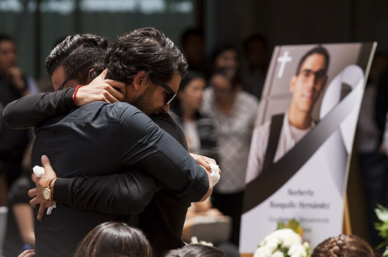 Dos hombres se abrazan en un funeral