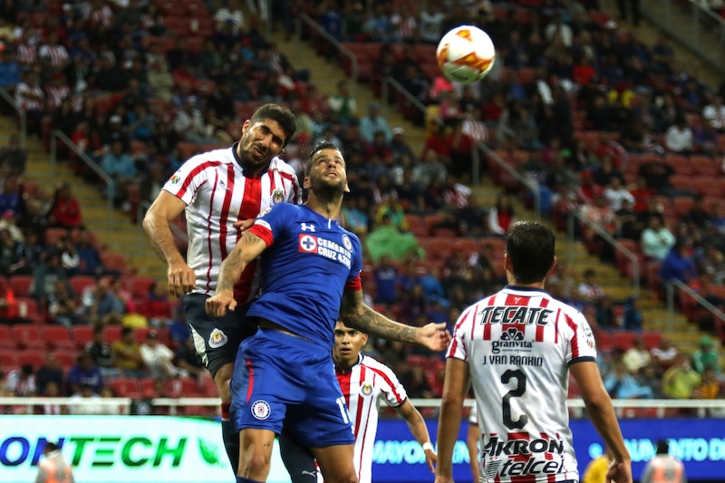 Jugadores de fútbol disputando un balón aéreo.