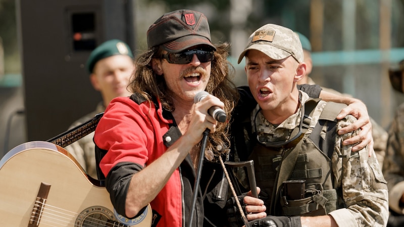 Cantante ucraniano abraza a un soldado en un concierto.