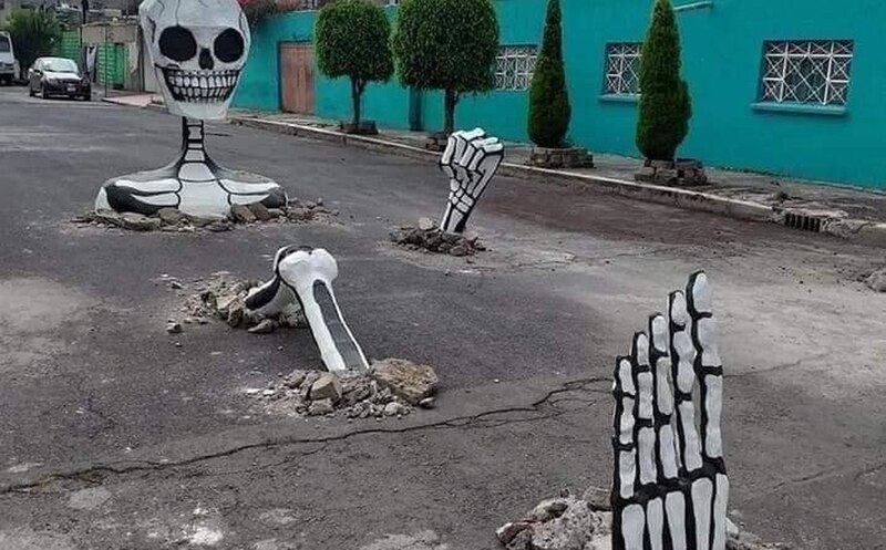 Un esqueleto gigante emerge de la calle en una espeluznante broma de Halloween