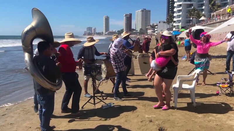 Banda sinaloense tocando en la playa
