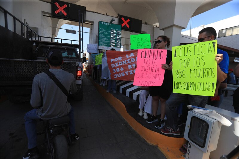 Manifestantes bloqueando el puente internacional Santa Fe con pancartas, en protesta por el caso del crematorio en Ciudad Juárez