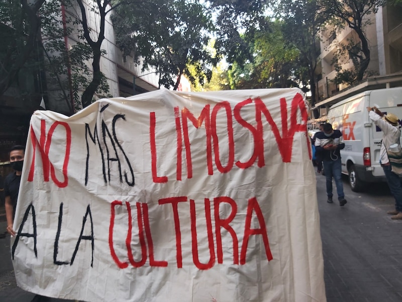 En la imagen se observa una pancarta con la consigna "No más limosna a la cultura" puesta durante una manifestación que exigía más presupuesto al INAH