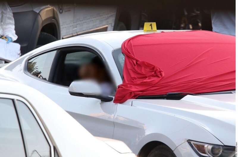 Mustang blanco cubierto con una tela roja