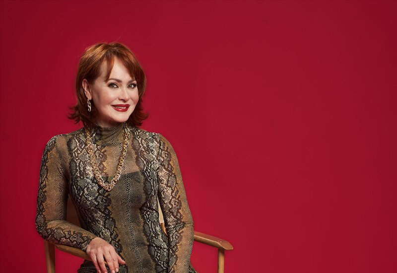 Mujer con vestido de serpiente y collar de oro