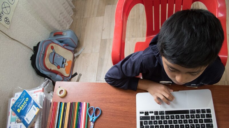 Niño usando una computadora portátil en casa