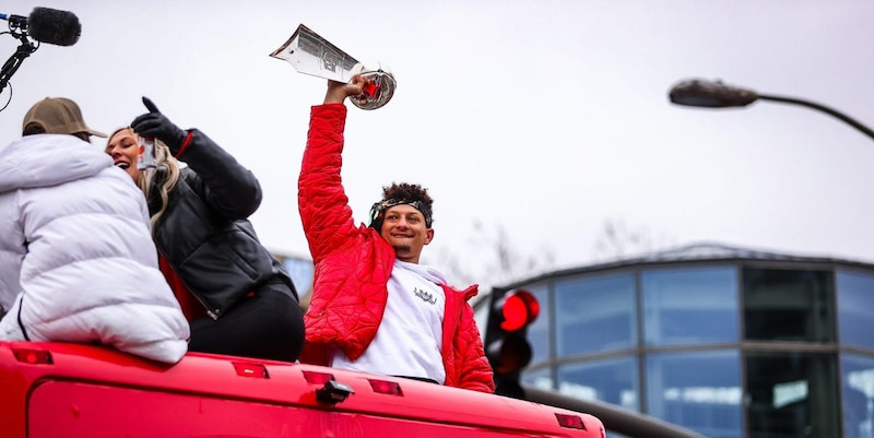 Jugador de fútbol americano sosteniendo un trofeo