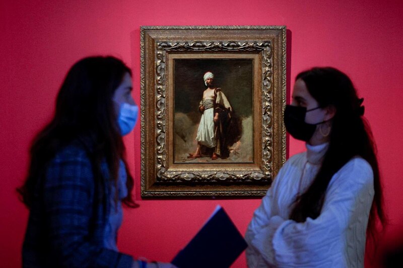 Dos mujeres observan un cuadro en un museo.