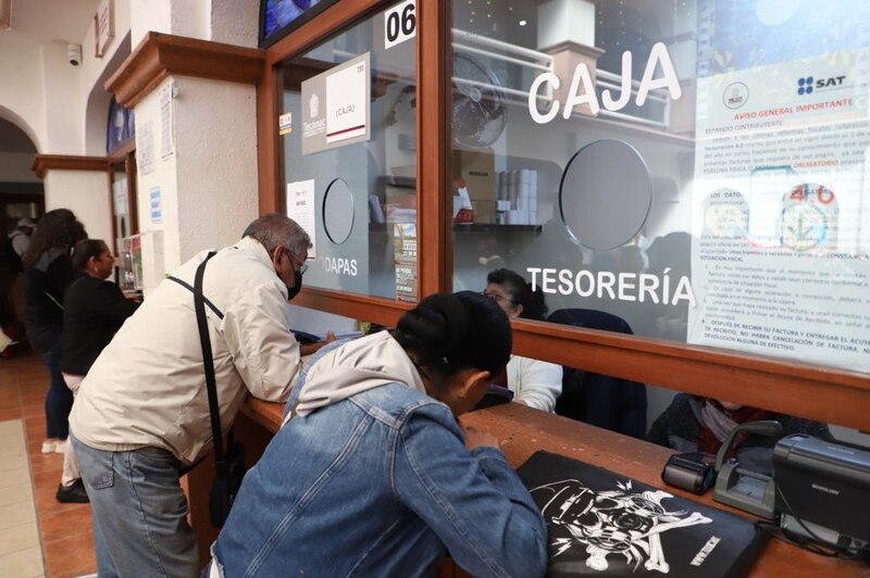 Title: Imagen de personas haciendo fila en una oficina del SAT