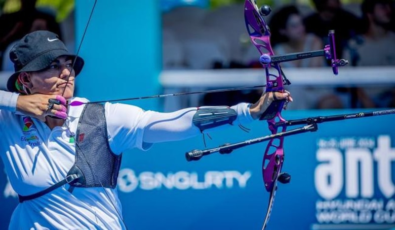 Mujer arquera apunta con su arco en una competencia