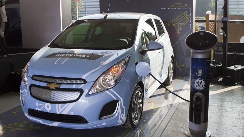 El Chevy Spark EV es un vehículo eléctrico que se recarga en una estación de carga.