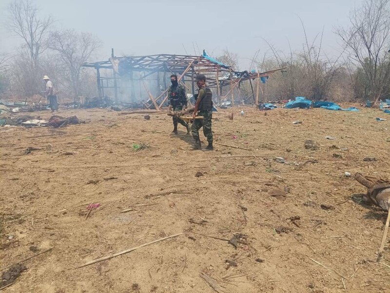 Soldados cargando un cuerpo de entre los escombros tras un bombardeo en Myanmar