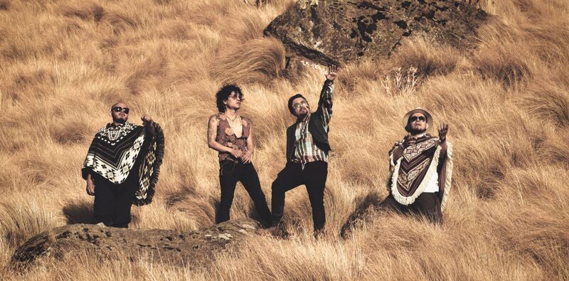 Tres hombres vestidos con ropa casual en un campo.