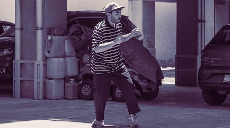 Un hombre haciendo kung fu en un estacionamiento