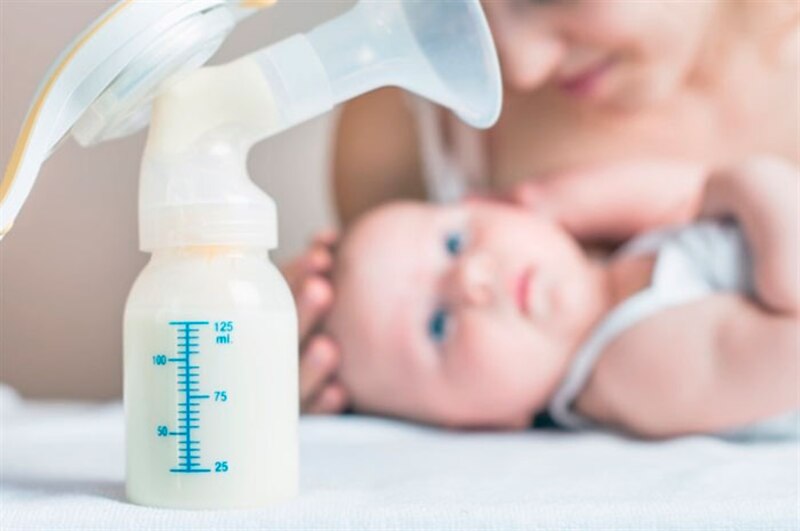 Madre amamantando a su bebé con un extractor de leche