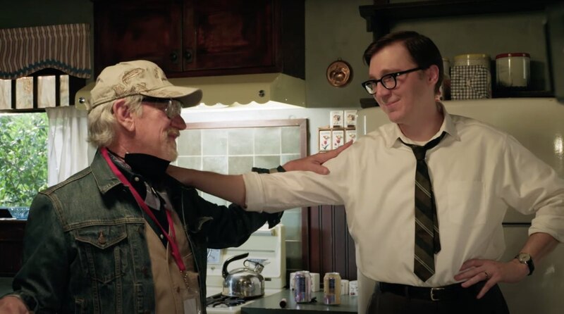 Un hombre mayor y un hombre más joven están discutiendo en una cocina.