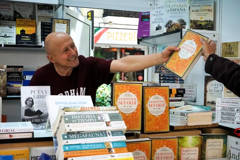 Un hombre sostiene un libro en una librería