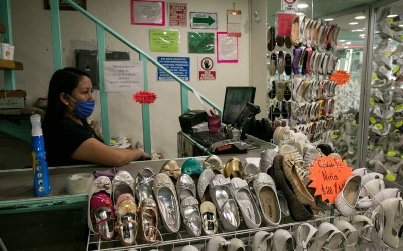 Una mujer atiende en una zapatería