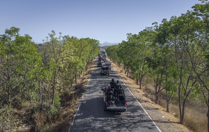 Un convoy de camionetas policiales se dirige a un operativo en una zona rural