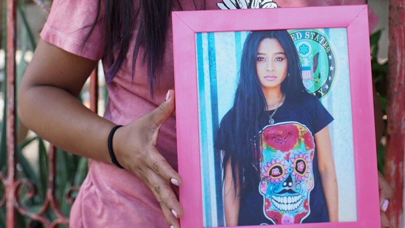 Joven sosteniendo un retrato de sí misma
