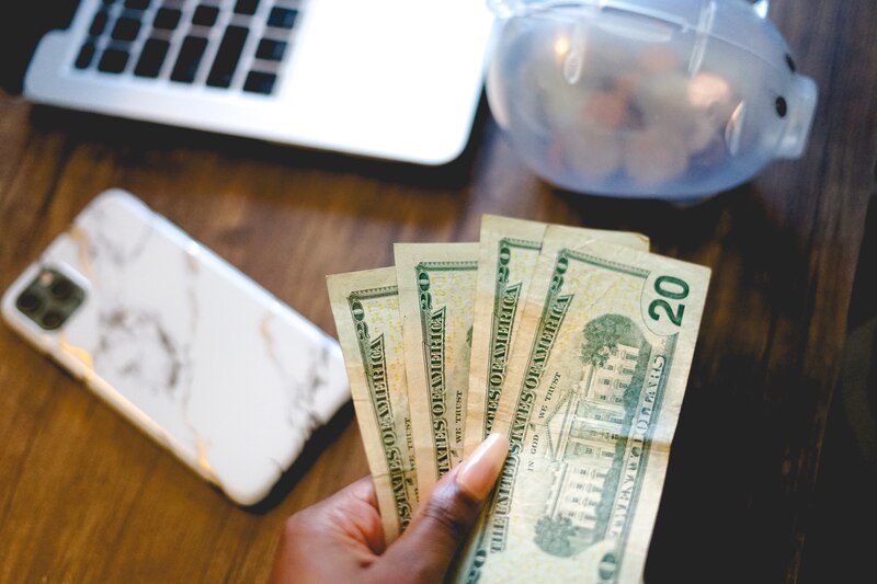 Mujer sosteniendo billetes de 20 dólares