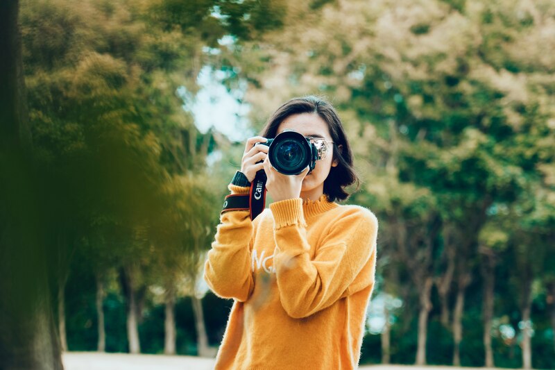Mujer tomando una foto con una cámara réflex