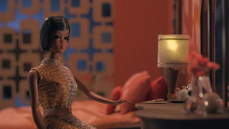 Muñeca Barbie sentada en una cama