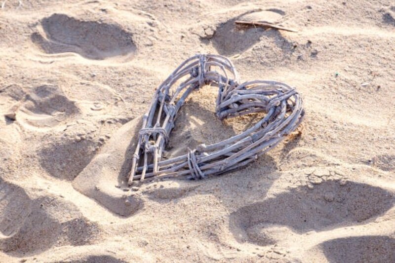 Corazón de mimbre sobre la arena de la playa