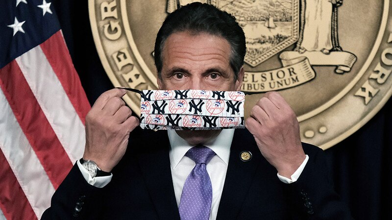El gobernador de Nueva York, Andrew Cuomo, muestra una mascarilla con el logo de los Yankees de Nueva York.