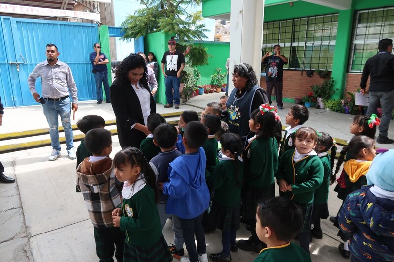 La candidata a la alcaldía de Iztapalapa, Clara Brugada, saluda a niños de un kínder durante su campaña electoral.