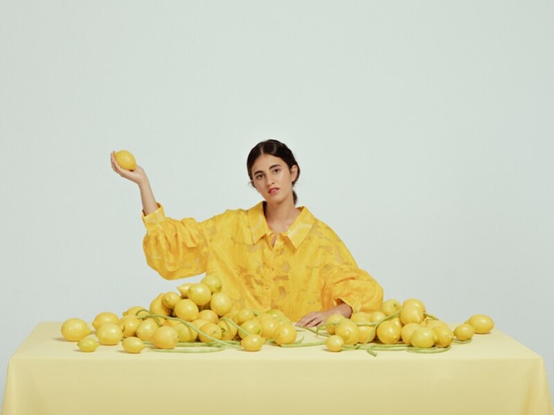 Mujer rodeada de limones
