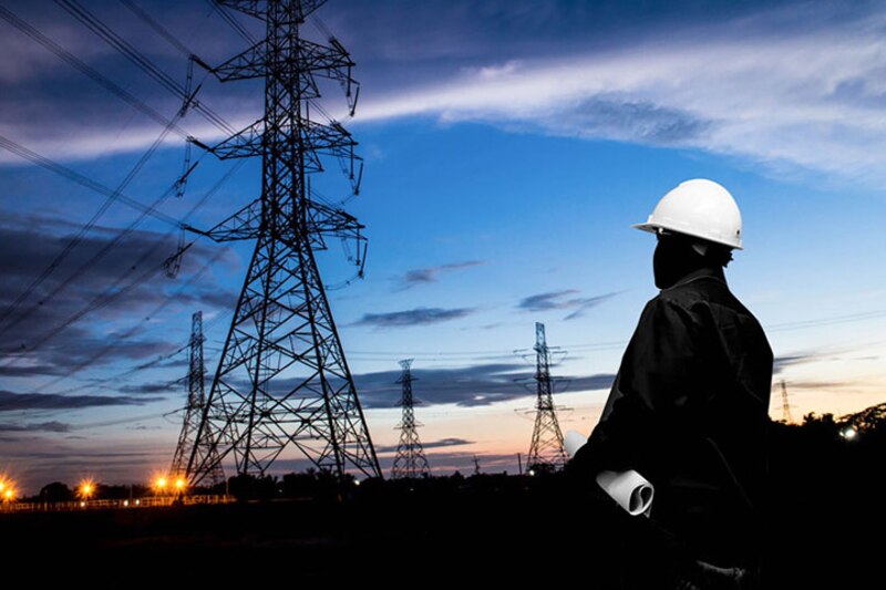 Ingeniero mirando torres de alta tensión