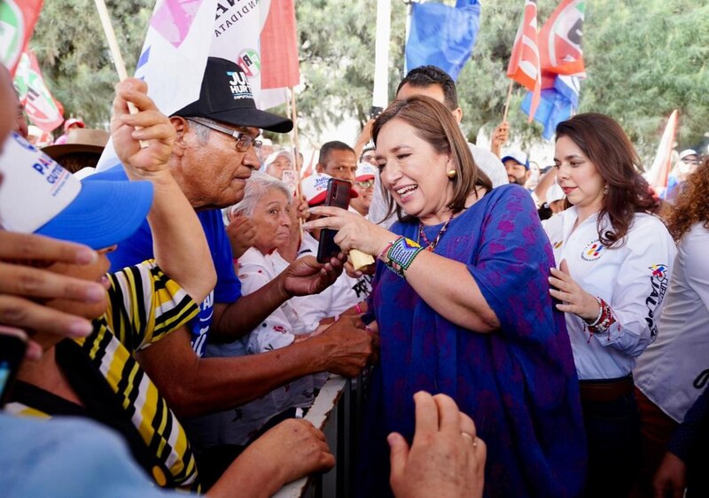 La candidata presidencial Xóchitl Gálvez se toma una foto con un simpatizante durante un mitin de campaña.