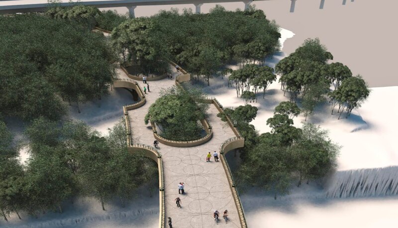 Un puente peatonal sobre un río en un parque
