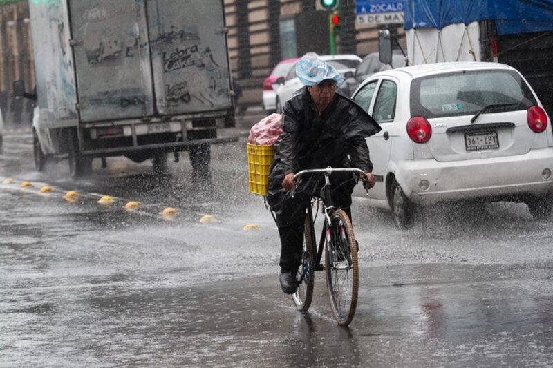 Ciclista se moja en la lluvia