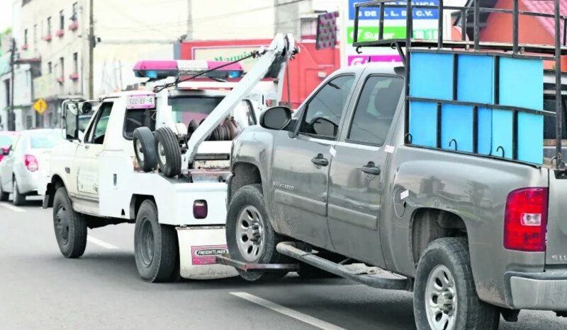 Grúa remolcando un coche en la ciudad
