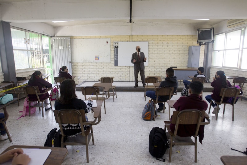 Profesor da clase a sus alumnos en el aula