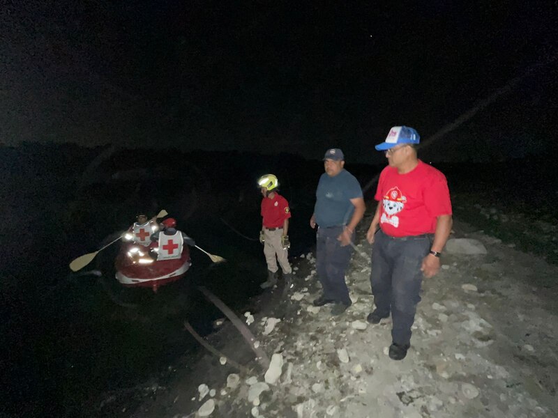 Rescatistas en una lancha ayudan a damnificados tras inundaciones