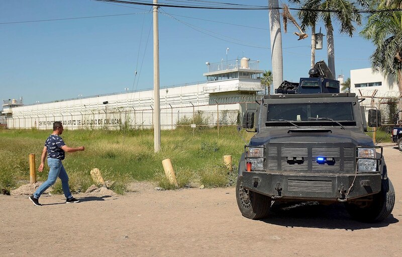 Militar mexicano camina frente a un vehículo militar