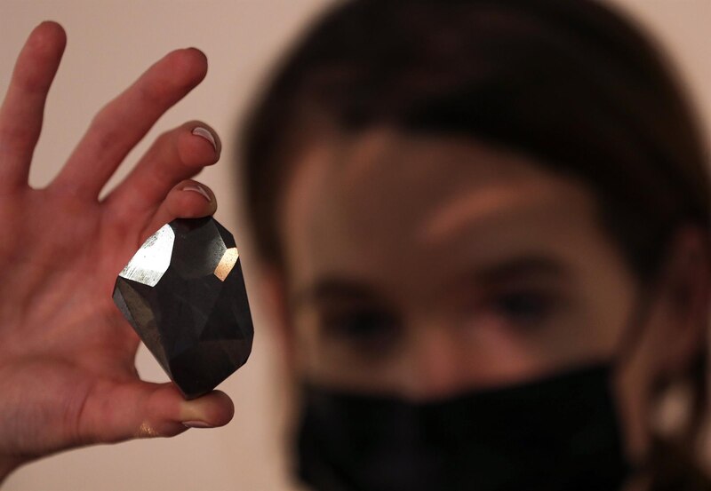 Científica sostiene en su mano un meteorito