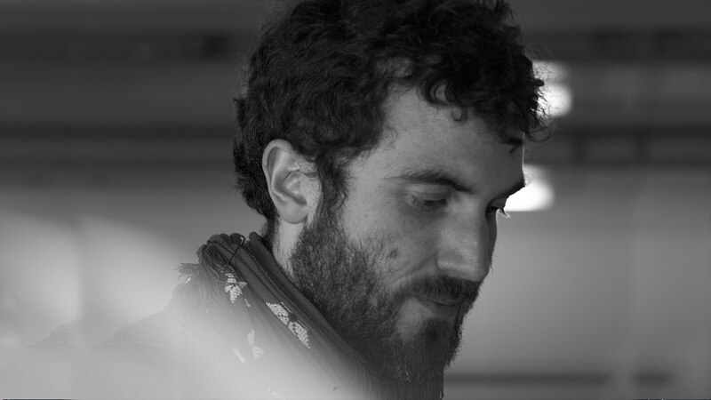 Retrato en blanco y negro de un hombre barbudo con el pelo rizado