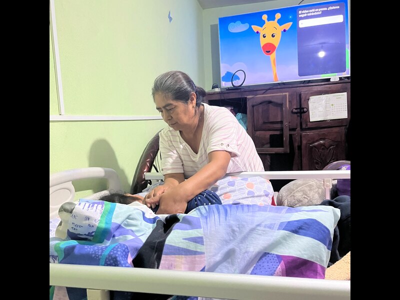 Abuela cariñosa cuida a su nieta en cama