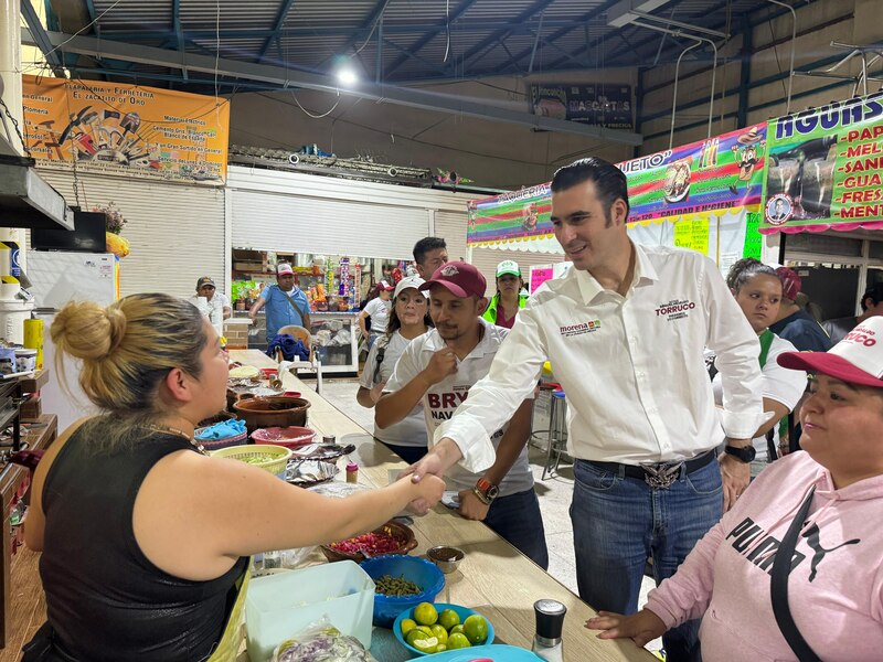 Title: El candidato a la alcaldía de Miguel Hidalgo, Mauricio Tabe, saluda a comerciantes en el mercado.