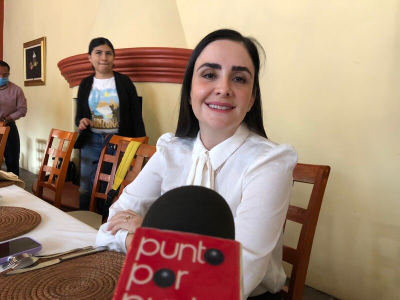 La periodista mexicana Anabel Hernández entrevistando a una mujer en un restaurante.