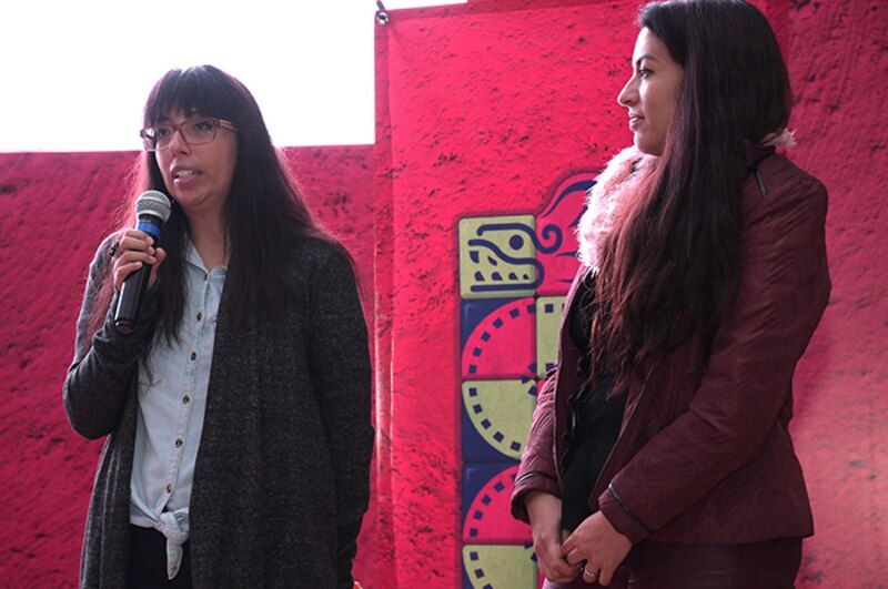 Dos mujeres están hablando en un evento.